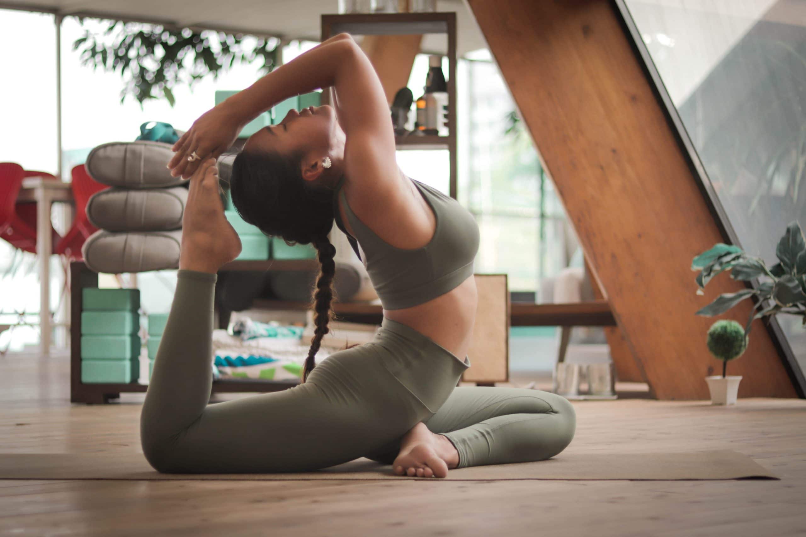 Frau macht Yogaübungen in Studio